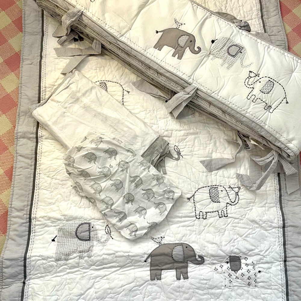 Pottery barn bumper, crib skirt, crib sheet and comforter.